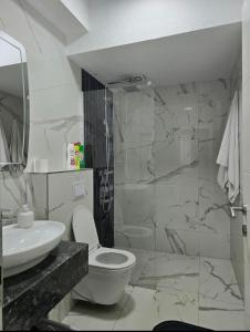 a bathroom with a toilet and a sink at White Ribbon Prizren in Prizren +16 photos