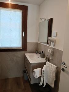 a bathroom with a sink and a mirror at NaturalmenteLucia in Cologno al Serio +11 photos