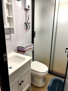 a small bathroom with a toilet and a sink at Casa Bonassola, Barra de Navidad in Barra de Navidad +30 photos