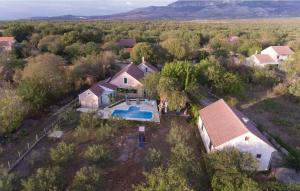 an aerial view of a house with a swimming pool at House Back to nature in Drniš