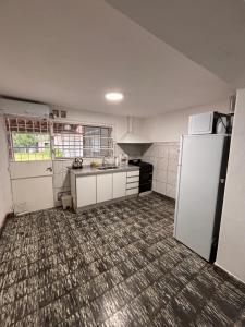 an empty kitchen with a refrigerator at Casa céntrica en JesusMaria in Jesús María +11 photos