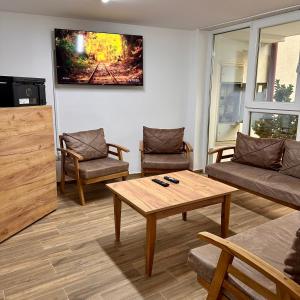a living room with a couch and a coffee table at In The House Hostel in Prishtinë
