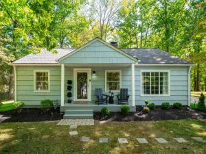 a small green house with a patio at Renovated Cottage - Game Room - Fire Pit - Sleeps 8 in Moreland Hills +38 photos