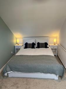 a bedroom with a white bed with two night stands at The Ferry Loft Montrose in Montrose