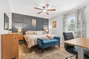 a bedroom with a bed with a ceiling fan and a desk at Spacious Northfield 4BR Escape near Cuyahoga Valley in Northfield