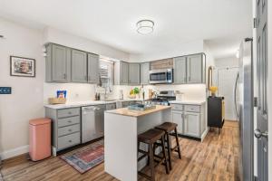 a kitchen with gray cabinets and a kitchen island at Spacious Northfield 4BR Escape near Cuyahoga Valley in Northfield