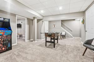 a game room with a table and a video game at Spacious Northfield 4BR Escape near Cuyahoga Valley in Northfield