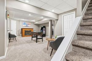 a living room with a staircase and a table at Spacious Northfield 4BR Escape near Cuyahoga Valley in Northfield