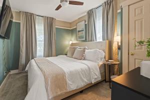 a bedroom with a white bed and a window at The Paper Plane Pool - Sauna - Poker Room - Sleeps 8 in Dayton