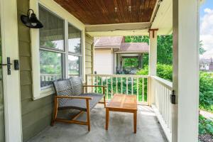 a porch with a chair and a table at The Paper Plane Pool - Sauna - Poker Room - Sleeps 8 in Dayton