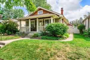 a house with a porch and a lawn at The Paper Plane Pool - Sauna - Poker Room - Sleeps 8 in Dayton +26 photos