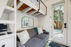 a living room with a couch and a window at Charming Tiny Home in Boise's North End in Boise