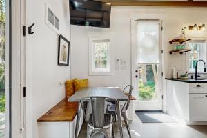 a kitchen with a table and chairs in it at Charming Tiny Home in Boise's North End in Boise