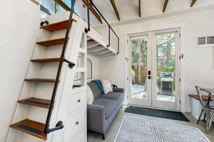a tiny house with a spiral staircase in a living room at Charming Tiny Home in Boise's North End in Boise