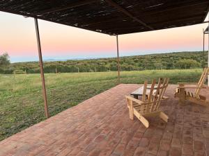 a patio with two chairs and a table with a view at Herdade dos Calvinos, Monte 2 - Alandroal in Parreiras
