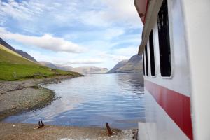 a view of a river from the side of a boat at Captains Room - Havborg in Hvannasund +4 photos