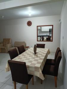 a dining room with a table and chairs at Casa com Piscina e Ar Condicionado in Imbé +12 photos