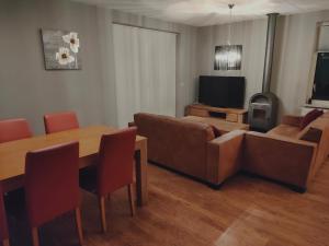 a living room with a couch and a table at vacation home 68 in Tzummarum
