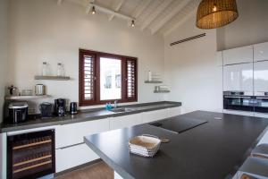 a kitchen with a sink and a counter top at Blue Bay Exclusive in Banda Abou