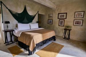 a bedroom with a large bed in a room at Coqui Coqui Papholchac Coba Residence & Spa in Coba