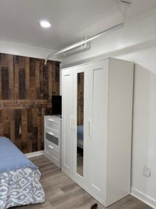 a bedroom with a bed and a white cabinet at dary hause in Indianapolis