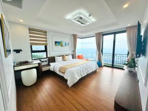 a bedroom with a bed and a large window at Time Villa in Tam Ðảo