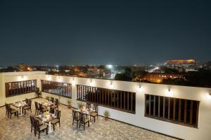 a patio with tables and chairs on a building at Rudransh Inn by Trulyy in Jodhpur