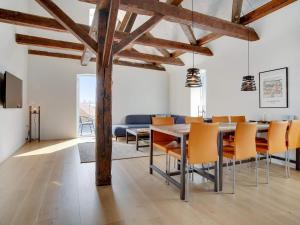 a dining room with a table and chairs at Two-Story Loft with Large Terrace in Løkken