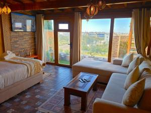 a living room with a bed and a couch at studio Azur rooftop with ocean view terrace privé in Essaouira