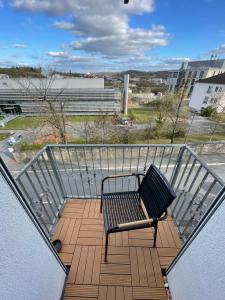 a balcony with a bench on top of a building at Giebelglück - 3 Zimmer, direkt an der UniKlinik, 2 Schlafzimmer, 4 Gäste, WLAN in Würzburg