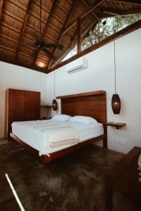a bedroom with a large bed in a room at Aqua Viva in Tulum