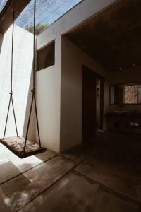 an empty room with a large window and a tripod at Aqua Viva in Tulum