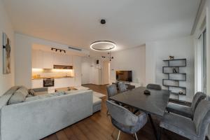 a living room with a couch and a table at Dedinje Luxury Apartment with Spa & Garage in Belgrade +39 photos