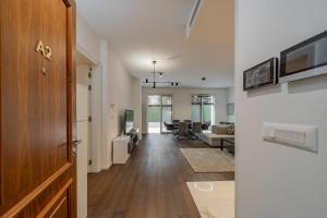 a hallway with a living room and a dining room at Dedinje Luxury Apartment with Spa & Garage in Belgrade