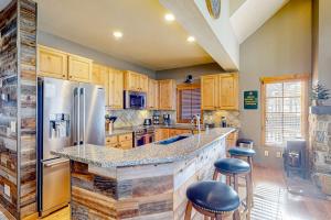 a kitchen with wooden cabinets and a counter with stools at Need for Speed in Donnelly