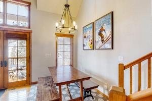 a dining room with a wooden table and a chandelier at Need for Speed in Donnelly +24 photos