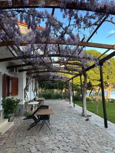 a wooden pergola with a bench under it at Fokiotrypa Seaside Retreat in Marathias