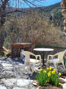 a picnic table and two chairs and a piano at Wild mountains in La Brigue