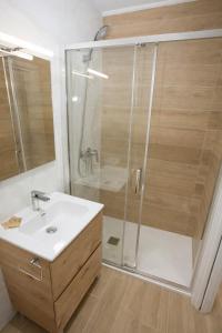 a bathroom with a shower and a sink at Apartamentos Turísticos El Cholo in Fisterra +12 photos