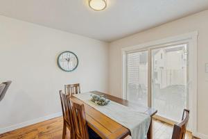 a dining room with a table and a clock on the wall at Park View Townhouse in Boise