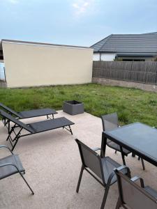 a group of picnic tables and chairs on a patio at La boîte à souvenirs in Xermaménil