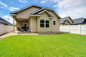 a house with a white fence and a yard at Sunglow Townhouse in Boise