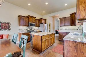 a large kitchen with wooden cabinets and a table at Sunglow Townhouse in Boise