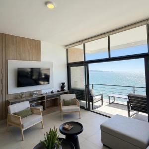 a living room with a view of the ocean at Kocoy Oceanfront condo in Punta Peninsula in Bahía Kino