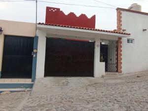 a house with two garage doors on a street at Los Malvones in Tequisquiapan