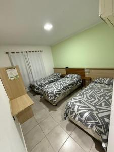 a room with two beds in a room at HOTEL DIAMANTE in Resistencia +62 photos