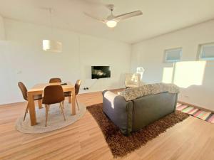a living room with a couch and a table at Arrifana Sea Stay in Aljezur