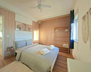 a bedroom with a bed with towels on it at Arrifana Sea Stay in Aljezur