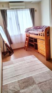 a bedroom with a bed and a window and a rug at Guest House Bamboo in Morioka +12 photos