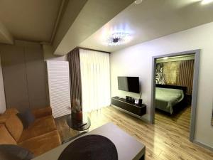 a living room with a couch and a bed and a mirror at Fly & Stay Otopeni Airport - Self Check-in in Otopeni +1 photo